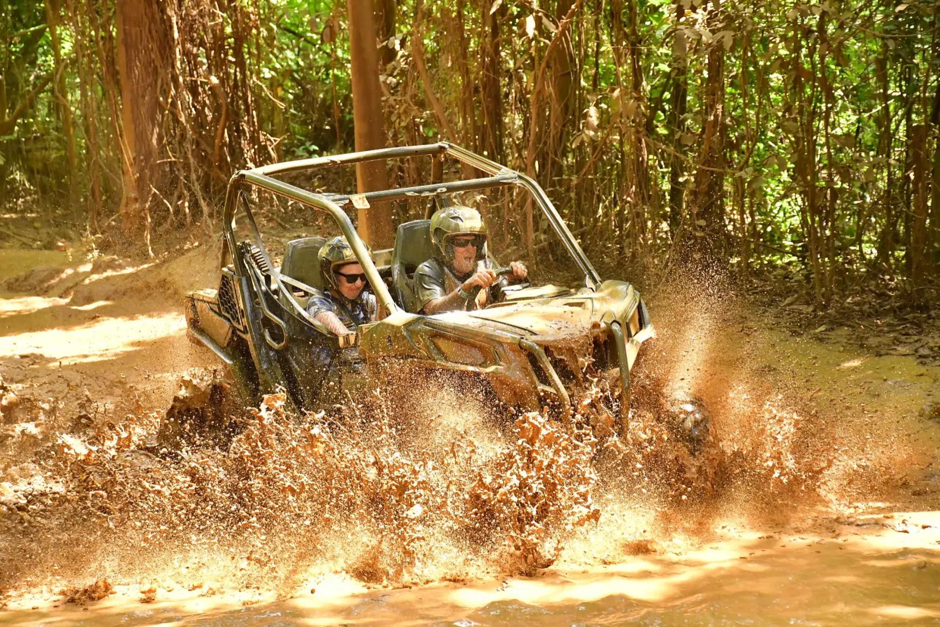 A dune buggy splashing through mud