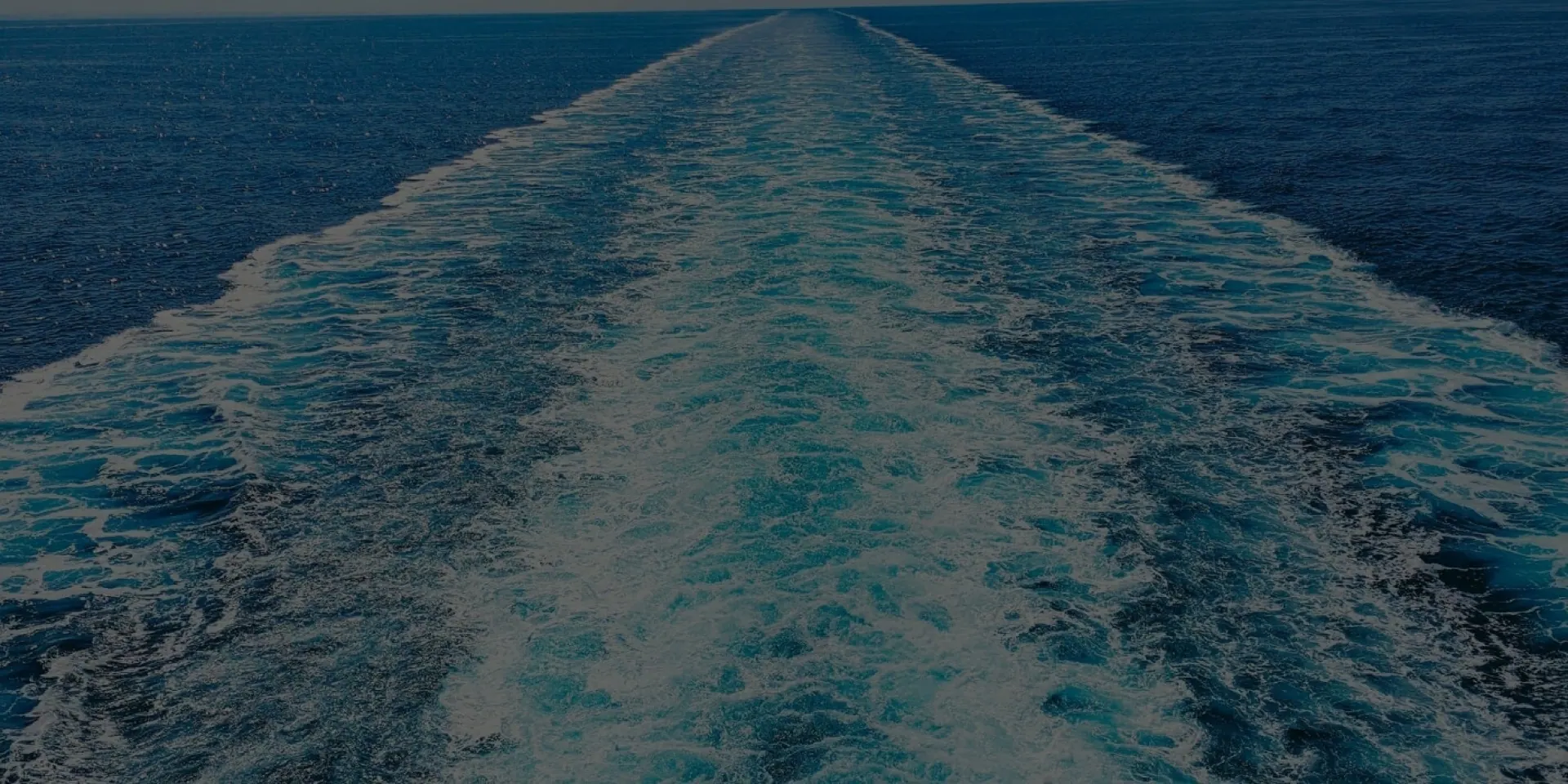 The ship's wake across open blue water